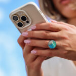 Okrogel prstan z modro zelenim vzorcem in pravim peskom iz reke Soče. Ročno izdelano darilo iz narave. Prikaz na roki.